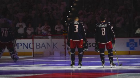 Columbus Blue Jackets defenseman Zach Werenski (8) and Columbus Blue Jackets defenseman Seth Jones (3) looks on during the National Athem before the game against the Carolina Hurricanes at PNC Arena. 