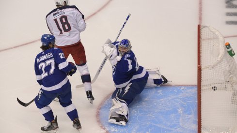 Columbus Blue Jackets center Pierre-Luc Dubois (18) scores a goal on a deflection past Tampa Bay Lightning goaltender Andrei Vasilevskiy (88) as Lightning defenseman Ryan McDonagh (27) defends in the first period in game one of the first round of the 2020 Stanley Cup Playoffs at Scotiabank Arena.