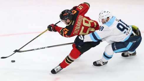 Blue Jackets prospect Yegor Chinakhov protecting the puck.