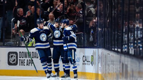 Feb 20, 2020; Columbus, Ohio, USA; Columbus Blue Jackets left wing Nick Foligno (middle) celebrates with teammate center Pierre-Luc Dubois (left) and right wing Oliver Bjorkstrand (right) after scoring a goal against the Philadelphia Flyers in the first period at Nationwide Arena.