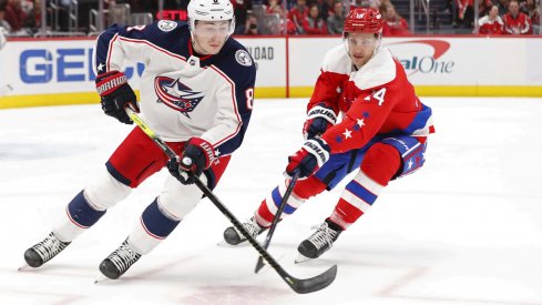 Dec 27, 2019; Washington, District of Columbia, USA; Columbus Blue Jackets defenseman Zach Werenski (8) skates with the puck as Washington Capitals right wing Richard Panik (14) defends in the first period at Capital One Arena.