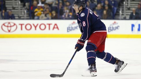 Columbus Blue Jackets defenseman Zach Werenski (8) checks Vegas Golden Knights left wing William Carrier (28) during the first period at T-Mobile Arena