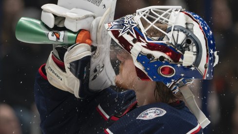 Columbus Blue Jackets goaltender Joonas Korpisalo hydrates during a stoppage in play at Nationwide Arena.