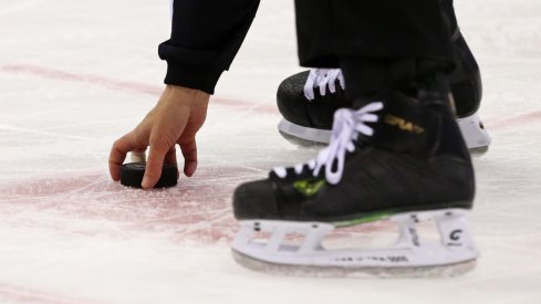  A NHL official collects the off ice Columbus Blue Jackets puck off the ice at Nationwide Arena. The Blue Jackets won 1-0. 