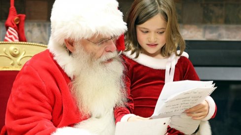 Lacie Shuff, 8, of Altoona reviews her wish list with Santa during Breakfast with Santa on Saturday, Dec. 1, 2018 at the Youth Center in Doanes Park in Pleasant Hill.