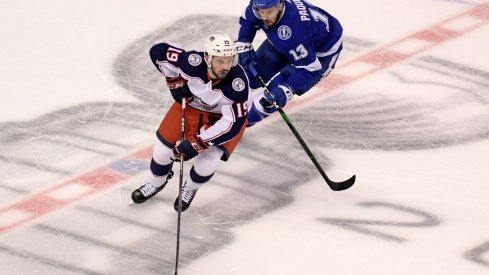 Aug 13, 2020; Toronto, Ontario, CAN; Columbus Blue Jackets center Liam Foudy (19) skates with the puck away from Tampa Bay Lightning center Cedric Paquette (13) during the first period in game two of the first round of the 2020 Stanley Cup Playoffs at Scotiabank Arena.