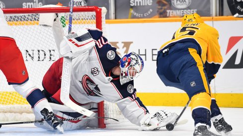 Columbus Blue Jackets goaltender Joonas Korpisalo (70) is unable to take the puck from Nashville Predators center Matt Duchene (95) during the first period at Bridgestone Arena.