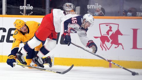 Nashville Predators center Nick Cousins (21) is called for interference on Columbus Blue Jackets defenseman Dean Kukan (46) late in the first period at Bridgestone Arena. 