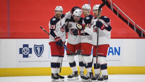 Alexandre Texier celebrates with teammates after scoring a goal against the Detroit Red Wings