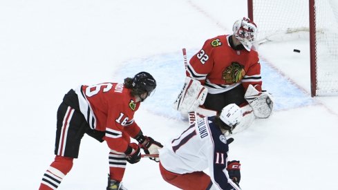 Columbus Blue Jackets center Kevin Stenlund (11) scores a goal on Chicago Blackhawks goaltender Kevin Lankinen (32) during the third period at United Center.