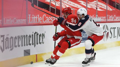 Jan 18, 2021; Detroit, Michigan, USA; Columbus Blue Jackets defenseman Zach Werenski (8) checks Detroit Red Wings right wing Bobby Ryan (54) during the second period at Little Caesars Arena.