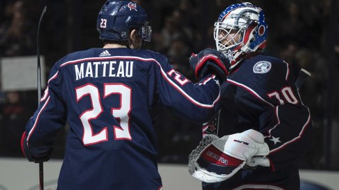 Mar 1, 2020; Columbus, Ohio, USA; Columbus Blue Jackets goaltender Joonas Korpisalo (70) is congratulated by center Stefan Matteau (23) after their win against the Vancouver Canucks at Nationwide Arena.