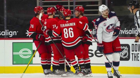 Feb 15, 2021; Raleigh, North Carolina, USA; Carolina Hurricanes left wing Brock McGinn (23) is congratulated by left wing Teuvo Teravainen (86) defenseman Jake Bean (24) right wing Sebastian Aho (20) and defenseman Brady Skjei (76) after his goal against the Columbus Blue Jackets during the third period at PNC Arena.