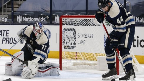 Columbus Blue Jackets defenseman Vladislav Gavrikov (44) attempts to play a rebound of a Joonas Korpisalo (70) save against the Carolina Hurricanes during the second period at Nationwide Arena.