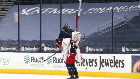 Columbus Blue Jackets goalie Elvis Merzlikins (90) and left wing Nick Foligno (71) celebrate the win after the game against the Nashville Predators at Nationwide Arena.