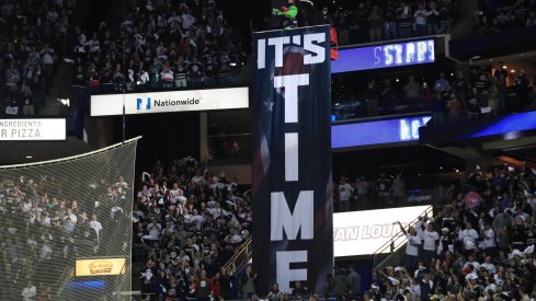 Apr 16, 2019; Columbus, OH, USA; Columbus mascot Stinger stands over the It's Time banner prior to game four of the first round of the 2019 Stanley Cup Playoffs in the game of the Tampa Bay Lightning against the Columbus Blue Jackets at Nationwide Arena.