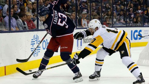 Sep 28, 2018; Columbus, OH, USA; Columbus Blue Jackets defenseman Gabriel Carlsson (53) passes the puck away from Pittsburgh Penguins right wing Bryan Rust (17) during the first period at Nationwide Arena.