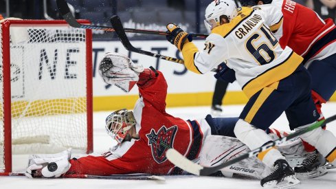  Elvis Merzlikins reaches to make a save against Nashville Predators center Mikael Granlund