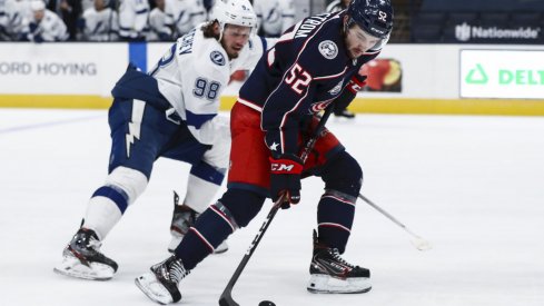 Jan 21, 2021; Columbus, Ohio, USA; Tampa Bay Lightning defenseman Mikhail Sergachev (98) skates as Columbus Blue Jackets center Emil Bemstrom (52) controls the puck at Nationwide Arena.