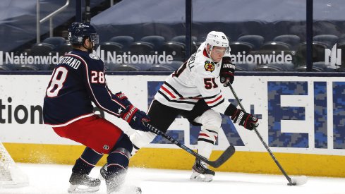 Chicago Blackhawks defenseman Ian Mitchell (51) and Columbus Blue Jackets right wing Oliver Bjorkstrand (28) chase down a loose puck during the first period at Nationwide Arena.