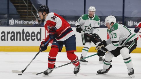 Feb 2, 2021; Columbus, Ohio, USA; Columbus Blue Jackets center Jack Roslovic (96) looks to pass as Dallas Stars defenseman Mark Pysyk (13) defends during the first period at Nationwide Arena.