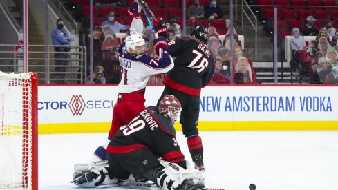Carolina Hurricanes goaltender Alex Nedeljkovic (39) with defenseman Brady Skjei (76) turns the shot away from Columbus Blue Jackets left wing Nick Foligno (71) during the first period at PNC Arena. 