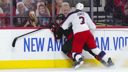 Mar 18, 2021; Raleigh, North Carolina, USA; Columbus Blue Jackets defenseman Seth Jones (3) checks Carolina Hurricanes left wing Warren Foegele (13) during the second period at PNC Arena.