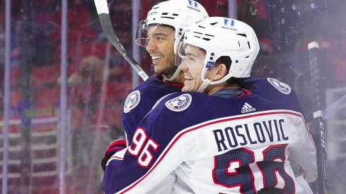 Seth Jones and Jack Roslovic celebrate an OT game winning goal