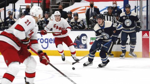 Mar 25, 2021; Columbus, Ohio, USA; Columbus Blue Jackets center Jack Roslovic (96) carries the puck as Carolina Hurricanes center Martin Necas (88) trails the play during the first period at Nationwide Arena.