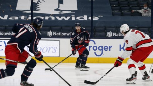 Columbus Blue Jackets right wing Oliver Bjorkstrand (28) looks to pass as Carolina Hurricanes defenseman Brady Skjei (76) defends during the first period at Nationwide Arena.