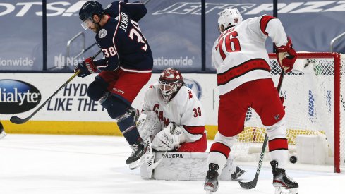 Columbus Blue Jackets forward Boone Jenner competes for the puck against Brady Skjei of the Carolina Hurricanes at Nationwide Arena.