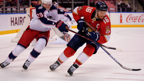 Florida Panthers center Aleksander Barkov (16) and Columbus Blue Jackets right wing Patrik Laine (29) chase a loose puck during the second period at BB&T Center.