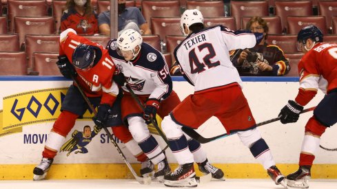 Apr 20, 2021; Sunrise, Florida, USA; Florida Panthers left wing Jonathan Huberdeau (11) protects the puck from Columbus Blue Jackets left wing Eric Robinson (50) during the third period at BB&T Center.
