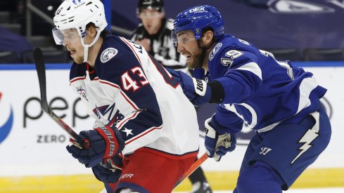 Columbus Blue Jackets defenseman Mikko Lehtonen (43) and Tampa Bay Lightning right wing Barclay Goodrow (19) skate after the puck during the first period at Amalie Arena.