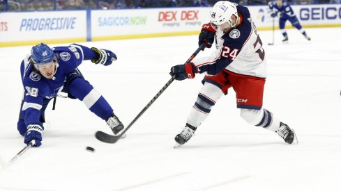 Columbus Blue Jackets left wing Nathan Gerbe (24) passes the puck as Tampa Bay Lightning defenseman Mikhail Sergachev (98) during the second period at Amalie Arena.