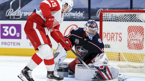 Apr 27, 2021; Columbus, Ohio, USA; Columbus Blue Jackets goaltender Elvis Merzlikins (90) makes a save in net against Detroit Red Wings left winger Jakub Vrana (15) in the overtime period at Nationwide Arena.