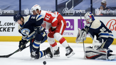 Columbus Blue Jackets defenseman Andrew Peeke (2) reacts after blocking a shot in front of Detroit Red Wings center Luke Glendening (41) as Columbus Blue Jackets goaltender Matiss Kivlenieks (80) defends the net in the second period at Nationwide Arena.