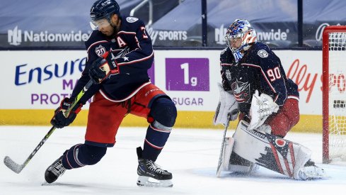 Seth Jones (3) reacts as goaltender Elvis Merzlikins makes a save in net against the Detroit Red Wings