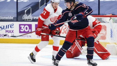 May 8, 2021; Columbus, Ohio, USA; Columbus Blue Jackets right wing Patrik Laine (29) deflects the puck in the air along side Detroit Red Wings defenseman Dennis Cholowski (21) in the third period at Nationwide Arena.