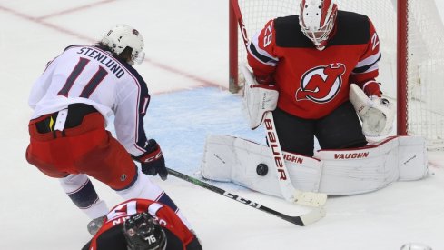 New Jersey Devils goaltender Mackenzie Blackwood (29) makes a save on Columbus Blue Jackets center Kevin Stenlund (11) during overtime at Prudential Center. 