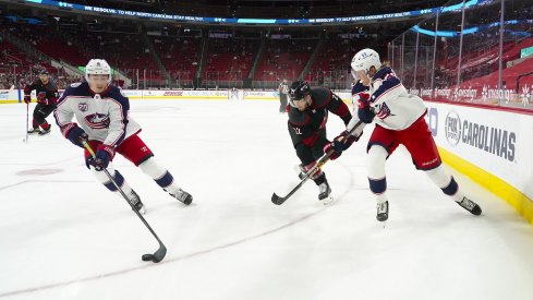 Zach Werenski and Patrik Laine skate against the Carolina Hurricanes