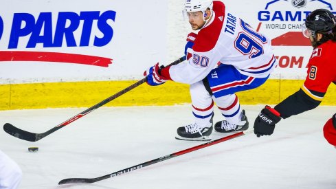 Tomas Tatar protects the puck against the Calgary Flames