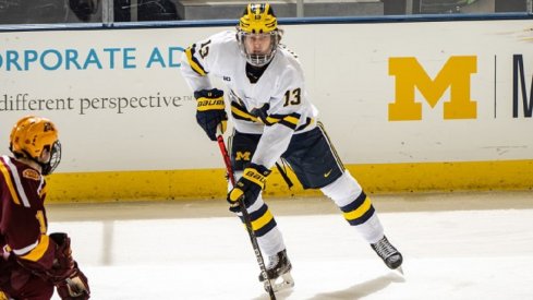 Kent Johnson skates with the puck against the University of Minnesota