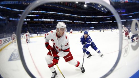 Carolina Hurricanes defenseman Jake Bean (24) skates with the puck as Tampa Bay Lightning center Blake Coleman (20) attempts to defend during the second period at Amalie Arena.