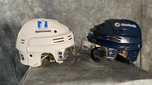 Blue Jackets helmets with advertisements.