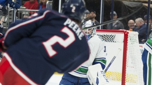 Vancouver Canucks goaltender Louis Domingue (30) makes a save on a shot by Columbus Blue Jackets defenseman Andrew Peeke (2) in the second period at Nationwide Arena.