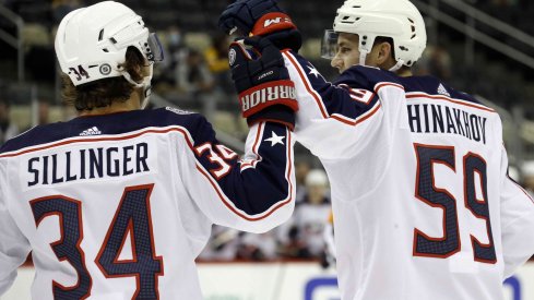 Sep 27, 2021; Pittsburgh, Pennsylvania, USA; Columbus Blue Jackets forward Yegor Chinakhov (59) celebrates with forward Cole Sillinger (34) after scoring a goal against the Pittsburgh Penguins during the first period at PPG Paints Arena.