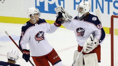Sep 27, 2021; Pittsburgh, Pennsylvania, USA; Columbus Blue Jackets defenseman Stanislav Svozil (81) congratulates goalie Jet Greaves (60) after the Blue Jackets shutout the Pittsburgh Penguins 3-0 at PPG Paints Arena.