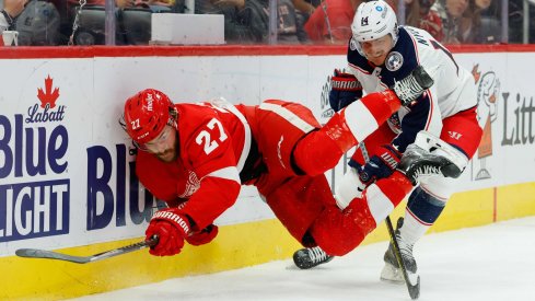 Oct 19, 2021; Detroit, Michigan, USA; Detroit Red Wings center Michael Rasmussen (27) and Columbus Blue Jackets center Gustav Nyquist (14) battle for the puck in the second period at Little Caesars Arena.