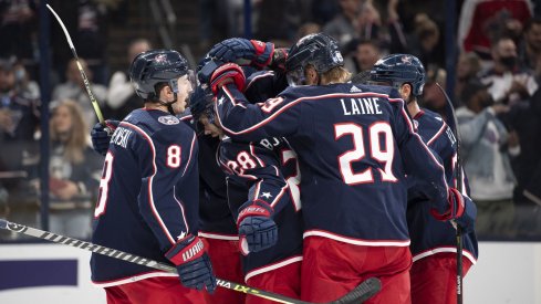 Oct 21, 2021; Columbus, Ohio, USA; Columbus Blue Jackets center Boone Jenner (38) celebrates with his team after scoring a goal against the New York Islanders in the second period at Nationwide Arena.